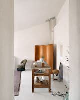 A 1930s screen by Jomaine Baumann shields a duct from view.