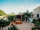 The courtyard and open-air kitchen are the home’s hub, where Ernesto’s guests can convene for meals he prepares using local ingredients. “There is an incredible amount of produce  in the area. It’s the simple things,” he says. Ellen designed the table and benches, which are surrounded by plantings added to the property.