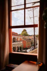 View of street through upstairs window of house in Bywater, New Orleans, renovated by Mitchell Kulkin and John Cameron Mitchell.