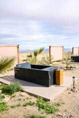 The soaking tubs are made of Nero Maquina marble sourced from Spain.  Photo 5 of 6 in How I Turned an Octagonal Joshua Tree House Into a Sustainable Oasis