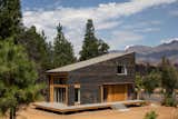 Prefab prefabricated house home residence by Method Homes and atelierjones in Greenville, Northern California, with fire-retardant and fire-resistant siding, mass-timber structure, wrap-around porch, and shed roof. 