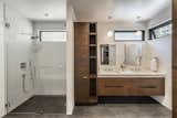Prefab prefabricated home house by Method Homes and CleverHomes x tobylongdesign with bathroom with grey and white tiling, dark-toned wood cabinetry, and glass enclosed shower booth.