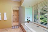 The primary bathroom features an oversized soaking tub and large shower.