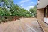 In the backyard, a large wooden deck provides plenty of space for outdoor entertaining.