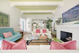 Colorful furniture complements the light green ceiling and brickwork in the living room.