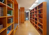 Custom built wooden shelving lining one of the hallways provides ample storage.