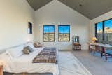 The large primary bedroom frames striking desert views and offers direct outdoor access.