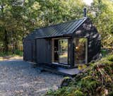 Kabn prefab prefabricated off-grid, boutique retreat cabin holiday stay tiny home on the shores of Loch Fyne, Scotland, with gabled roof and blackened shou sugi ban cladding.