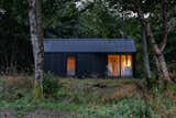 Kabn prefab prefabricated off-grid, boutique retreat cabin holiday stay tiny home on the shores of Loch Fyne, Scotland, with gabled roof and blackened shou sugi ban cladding.