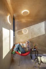 The round plywood lamps that dot the walls and ceiling are also designed by Minarc.