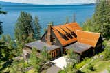 The compound of Stone Creek Camp sits on a lush 16-acre lot overlooking Flathead Lake.