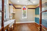Arched Brazilian cherry doors open to a spacious laundry room/pantry set near the kitchen.