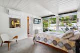 The primary bedroom features floor-to-ceiling sliding glass doors and an en suite bath.