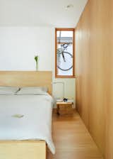 The bedroom adheres to the overall muted palette.