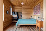 The bedrooms are finished from floor to ceiling with with rich wood cladding.