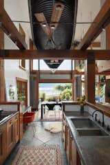 Herschel Supply Co. cofounder Lyndon Cormack had a cedar strip canoe that came with the purchase of his North Vancouver, British Columbia, home installed above the kitchen.  Photo 2 of 4 in Herschel Supply Co.’s Cofounder Really Loves Overhead Art