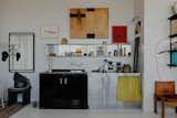 Thanks to a few good thrifty finds—like the $300 stainless steel fridge from Craigslist or the black wood countertop saved from the landfill—Ben and Emilio were able to cut costs while investing in more modular features, like the custom-made aluminum shelving ($100 each).