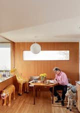 Strategically placed windows and wooden wall panels and flooring continue in the kitchen.