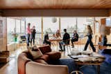 The open dining/living area looks out onto the deck via walls of windows.