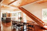 Exposed beams stretch across the main level, connecting the living areas and kitchen.