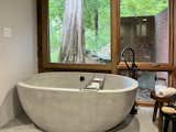 An oversized NativeStone soaking tub awaits in the primary en suite bath.