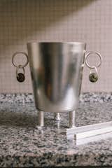 The sense of the surreal extends to her ice bucket with feet (and earrings) standing firmly on the kitchen counter.