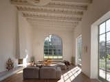 A large, curved window in the living room looks out onto the garden and echoes the archways in the central hall.