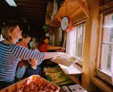 A local resident and farm co-op member weighs freshly harvested vegetables at EcoVillage at Ithaca, a sustainably living community in Ithaca, New York. Local residents purchase shares in the organic farm’s summer and fall harvest.