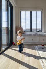 Durable—and kid-proof—luxury vinyl plank floors are softened with plush area rugs.&nbsp;