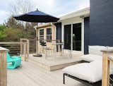 The umbrella, table, and chairs, with our sofa and lounge chair as well, in their new home on our deck.