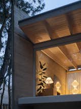 A board-formed concrete wall closes the ends of the home. The ceiling is made of eucalyptus planks.