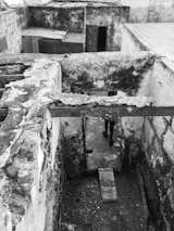 Black-and white photograph of dilapidated house with earthen floors and missing roofs in a home in Lanzarote, Canary Islands, Spain, before it was renovated by Patricia Betancourt Ramos.