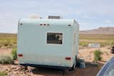 As he readies his 1,200-square-foot off-grid, solar-powered home, Rod Rylander lives in a pull-behind camper he bought for $2,000.