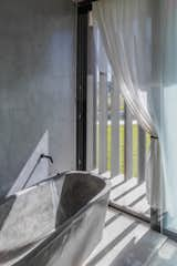 A bathroom built into the curve looks out over the yard and surrounding pampa.&nbsp;