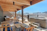 Floor-to-ceiling glass doors connect the living areas with the adjacent covered deck.&nbsp;