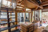 Exposed wooden beams infuse the living area with a sense of warmth.