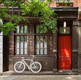 Nestled in the heart of Manhattan, at the crossroads of the West Village, SoHo, and Greenwich, the multi-level house extends a cheerful welcome with a bright red front door.