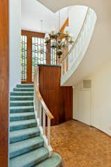 A curvaceous staircase leads to the three bedrooms on the upper level.