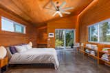 In the detached guesthouse, polished concrete floors contrast with the Douglas fir walls and ceiling.