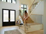 The home’s entrance features a grand vaulted foyer space with a cantilevered staircase up to the second floor. "We worked with Marvin Ultimate series to create the stair tower so we could stack windows together, and really create this kind of feeling of a wall of glass," says DeBaker.&nbsp;