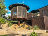 The landscaped backyard features a floating gazebo and a sparkling pool with a diving board.