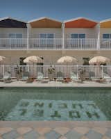 The zigzag roof’s soffits are painted a different pastel color above each guest room balcony.