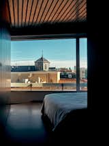 Rooftops and dome of church seen through window of a bedroom in an apartment in Madrid, Spain, renovated by architect Eduardo Mediero.