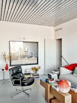 In the living area, a coffee table by Tornasol Studio holds a Xiaomi projector and a green-and-red bowl from Mallorcan ceramics studio Paparkone.