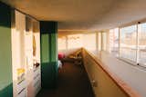Hallway leading to bedroom in lofted second-floor of a factory converted into an apartment by Gabriele Schiavon, creative director of Barcelona-based design studio Lagranja.
