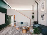 An Eames leg splint hangs on the stairway leading to the mezzanine.