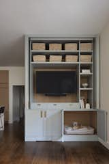 Storage in the breakfast nook transforms to a place for the family dog to hang out. 