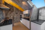 Wrapped in concrete, the kitchen has ample counter space and high-end appliances.