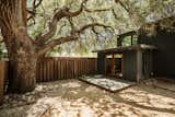 The former carriage house includes a kitchen, a living area, a bedroom, a bath, and an office nook.