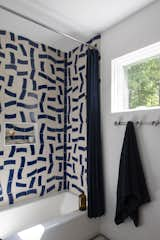 One of the home’s two bathrooms has a&nbsp; shower clad in playfully patterned tiles.